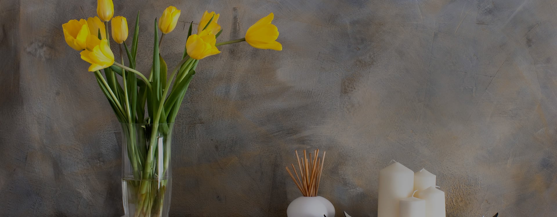 painting of vase with yellow flowers next to incense and candles